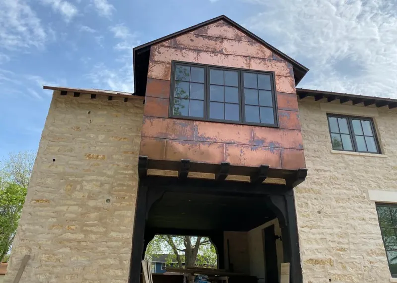 Copper metal panel facade on a stone building for Roof Repair in Southaven